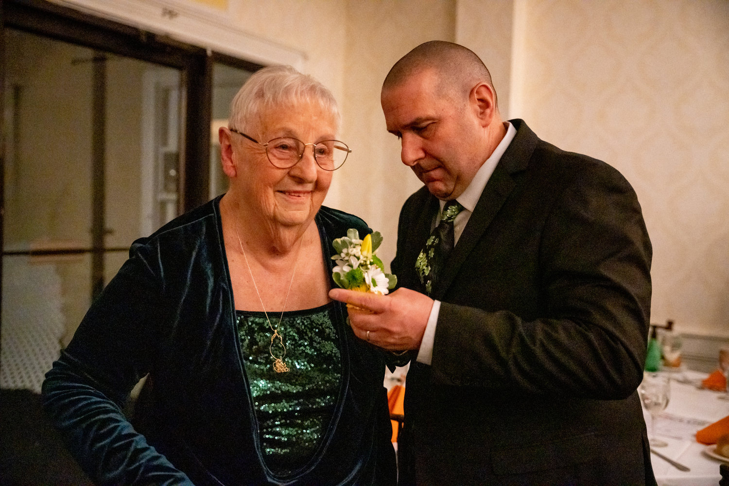 Bayport-Blue Point St. Patrick’s grand marshal of 2023, Constance Haab, gets a corsage pinned to her lapel.